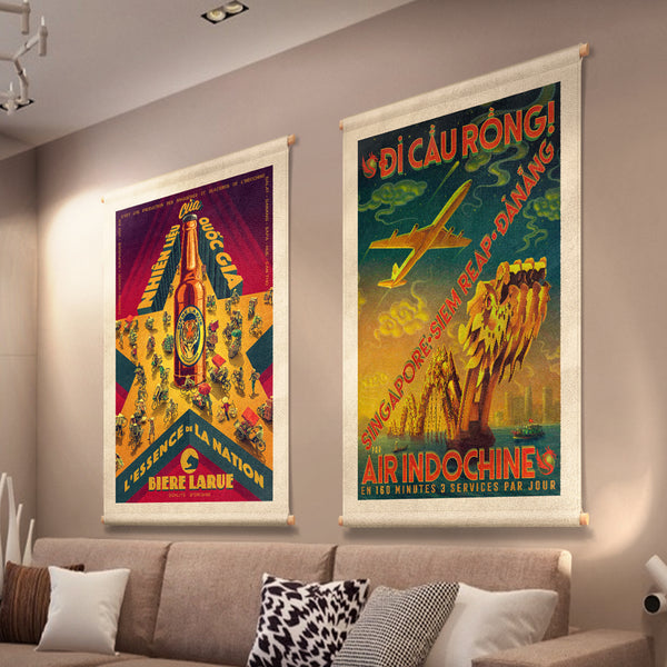 A stylized Vietnamese street scene, printed on canvas fabric, hanging on a lounge wall, including a star, a beer bottle and people on bicycles and motorcycles.