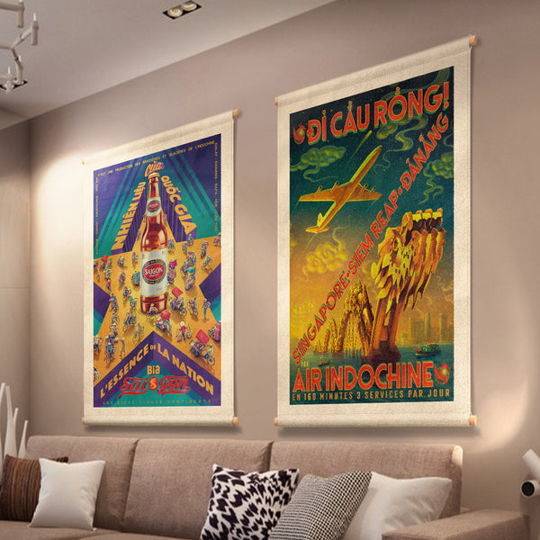 A stylized Vietnamese street scene, printed on canvas fabric, hanging on a lounge wall, including a star, a beer bottle and people on bicycles and motorcycles.
