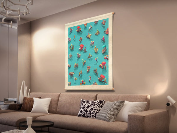 A Vietnamese street scene printed on canvas fabric, hanging on a lounge wall, with a pattern of people on bicycles and motorcycles.