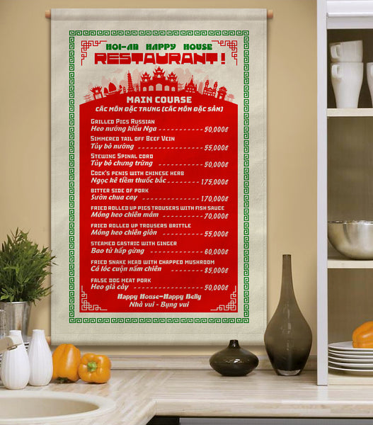A Vietnamese restaurant menu printed on canvas fabric, hanging on a wall in a kitchen, displaying a list of dishes in English and Vietnamese with corresponding prices.