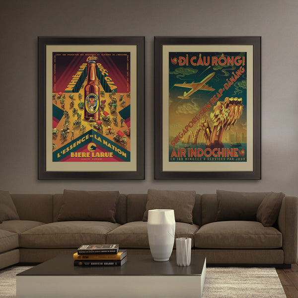 A stylized Vietnamese city portrait, printed on fine art paper, framed and hanging on a lounge wall, including a dragon bridge, an aeroplane, boats, buildings and a dramatic night sky.