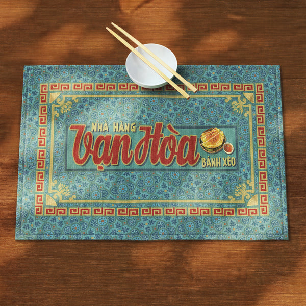 A distinct Vietnamese table mat, printed on canvas fabric, featuring a Vietnamese shop sign artwork, border and pattern.
