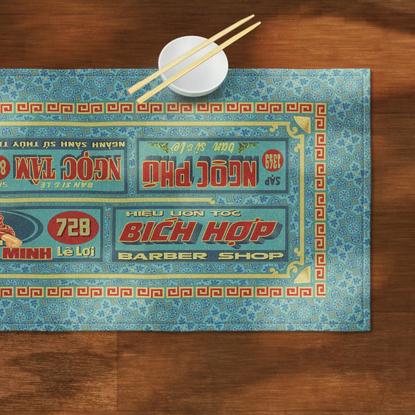 A distinct Vietnamese table runner, printed on canvas fabric, featuring Vietnamese shop sign artwork, borders and patterns.